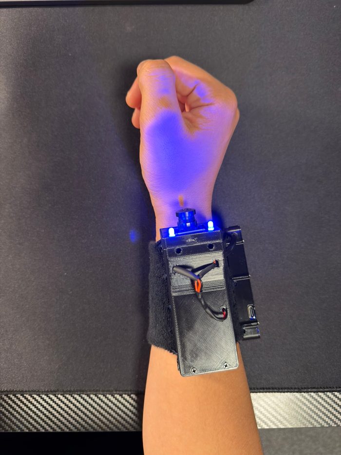 Wrist camera prototype on a forearm with LEDs active
